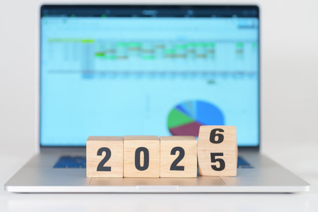 2025 end year to Happy New Year 2026 block with computer laptop background. Goal, Target,...