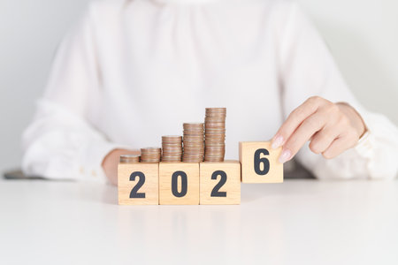 Happy New Year 2026 with Coins stack. Money, Budget, tax, investment, financial, savings and New Year Resolution conceptsの写真素材