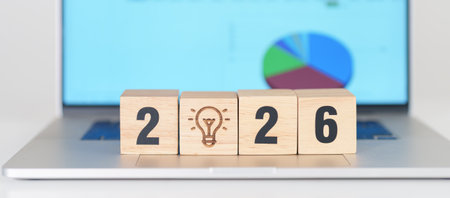 2026 Year block with lightbulb icon against computer laptop background. Business Idea, Creative,...