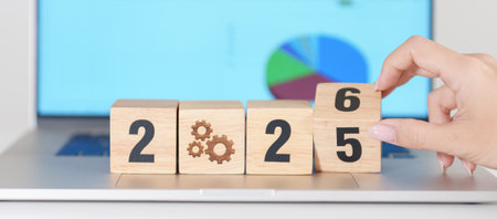 2025 end year to Happy New Year 2026 block with gear icon against laptop computer. Business Process, Team, teamwork, Goal, Target, Resolution, strategy, plan, Action, motivation, change and brainstormの写真素材