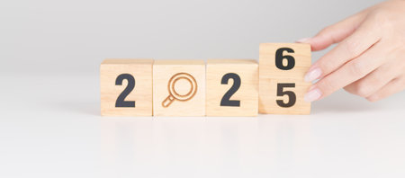 2025 year change to 2026 year block with magnifying glass icon. SEO, Search Engine Optimization,...