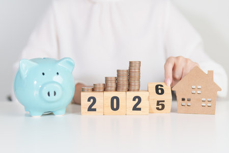Happy New Year 2026 with house model and Coins stack. real estate, Home loan, tax, investment,...