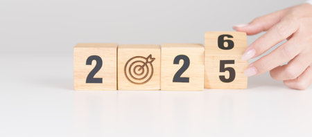 2025 year change to 2026 year block with dartboard icon. Goal, Target, Resolution, strategy, plan, Action, mission, motivation, and New Year start conceptsの写真素材