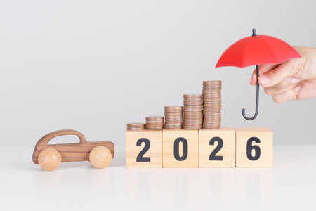 Happy New Year 2026 with red umbrella over money stack. car Insurance, Financial, vehicle Repair and...