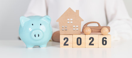 Happy New Year 2026 with car and Home model with coin stack. Car loan, Interest rate, real estate,...