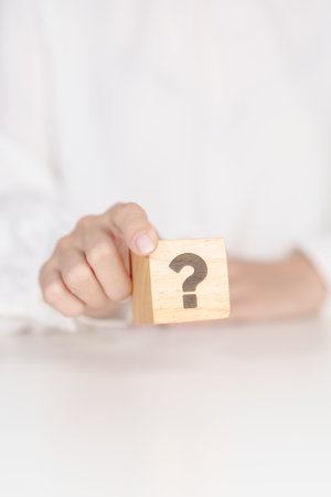 Wood block of Questions Mark sign. FAQ, frequency asked questions, Answer, Q and A, Information, Communication, problem and interrogation Conceptsの写真素材