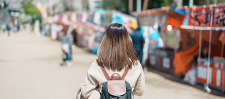 Woman tourist sightseeing Morioka Sakura Festival at Morioka Castle Ruins during Cherry Blossom in Spring, happy traveler travel in Iwate Park, Iwate prefecture, Japan. famous Landmark Travelの写真素材