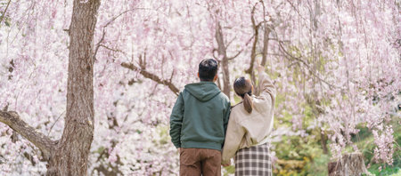 Couple tourist sightseeing Sakura Cherry Blossom in Spring, happy traveler travel in Tendo Park or Maizuru Park in Yamagata prefecture, Tohoku, Japan. famous Landmark for Travel and Vacationの写真素材