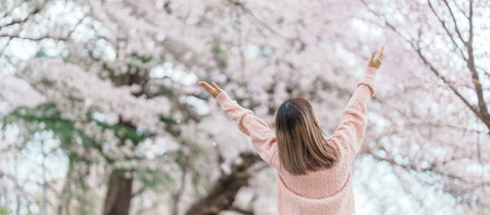 Woman tourist sightseeing Kajo Park Yamagata Castle Ruins with Sakura Cherry Blossom in Spring, happy traveler travel in Yamagata prefecture, Tohoku, Japan. famous Landmark for Travel and Vacationの写真素材