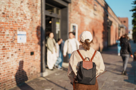 Woman tourist Visiting in Hakodate, happy Traveler sightseeing Kanemori Red Brick Warehouse in...