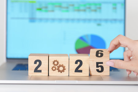 2025 end year to Happy New Year 2026 block with gear icon against laptop computer. Business Process,...