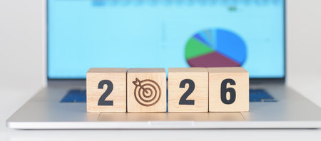 2026 Year block with dartboard icon against computer laptop background. Goal, Target, Resolution,...