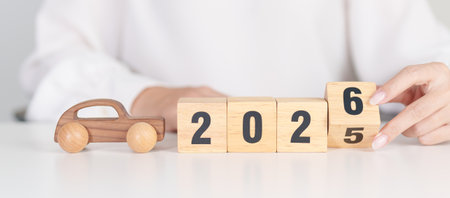 2025 end year to Happy New Year 2026 with Car model on table. Automobile Tax, Car Insurance,...