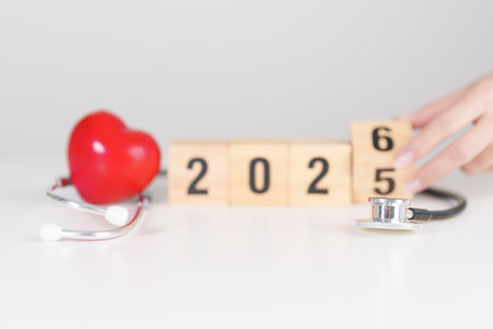 2025 end year to Happy New Year 2026 with Stethoscope of doctor and heart shape on table. health...