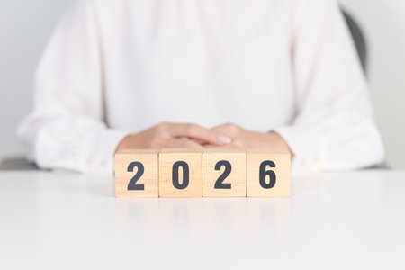 2026 year block on table. goal, Resolution, strategy, plan, start, budget, mission, action, motivation and New Year conceptsの写真素材