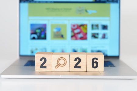 Happy New Year 2026 block magnifying glass icon against laptop background. Hiring, recruitment, job, jobless SEO, Search Engine Optimization and New Year conceptsの写真素材