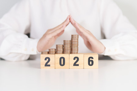 Happy New Year 2026 with hand cover money stack growing. Insurance, protection, safety and New year holiday Conceptsの写真素材
