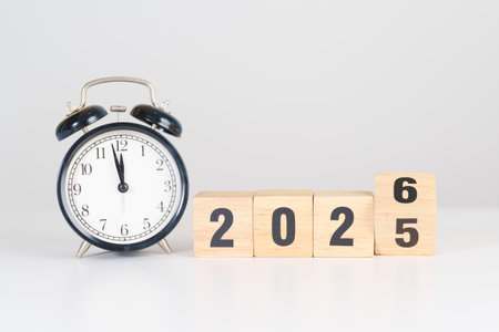 2025 end year to Happy New Year 2026 with vintage alarm clock. Christmas, New Start, Resolution,...