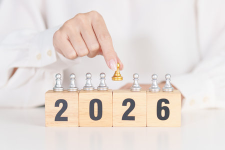 hand holding man chess figure from the crowd employee with 2026 Year block. Human resource...