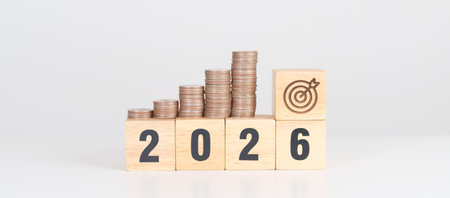 Happy New Year 2026 with Coins stack and dartboard icon. Strategy, goal, Money, Budget, tax, investment, financial, savings and New Year Resolution conceptsの写真素材