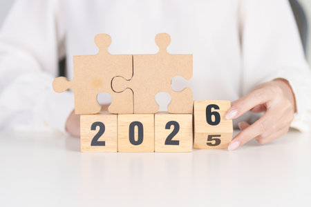 2025 year change to 2026 year block with jigsaw puzzle icon. Business Process, Team, teamwork, Goal, mission, Resolution, strategy, plan, Action, partnership, and New Year startの写真素材
