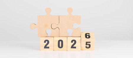 2025 year change to 2026 year block with jigsaw puzzle icon. Business Process, Team, teamwork, Goal, mission, Resolution, strategy, plan, Action, partnership, and New Year startの写真素材