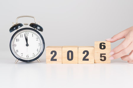 2025 end year to Happy New Year 2026 with vintage alarm clock. Christmas, New Start, Resolution, countdown, Goals, Plan, Action and Motivation Conceptの写真素材