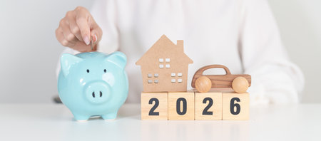 Happy New Year 2026 with car and Home model with coin stack. Car loan, Interest rate, real estate,...