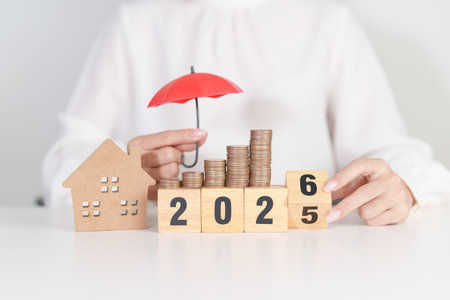 2025 end year to Happy New Year 2026 with red umbrella over money stack. Insurance, real estate,...