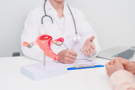 Woman patient consulting doctor with anatomy Uterus and Ovaries. Ovarian and Cervical cancer, Cervix...