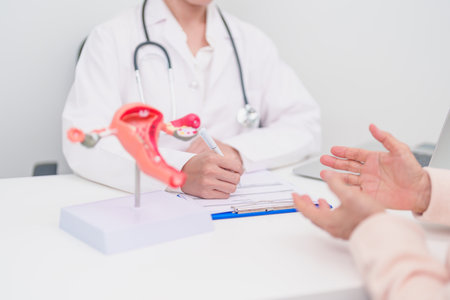 Woman patient consulting doctor with anatomy Uterus and Ovaries. Ovarian and Cervical cancer, Cervix disorder, Endometriosis, Hysterectomy, Uterine fibroids, Reproductive system and Pregnancy conceptの写真素材