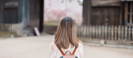 Woman tourist sightseeing Hirosaki Castle with Sakura Cherry Blossom in Spring, happy traveler travel in Hirosaki city, Aomori, Tohoku, Japan. Landmark famous in Japan. Travel and Vacation destinationの写真素材