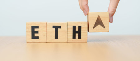 Hand change Wooden block with ETH or Ethereum text to UP and Down arrow symbol. cryptocurrency,...