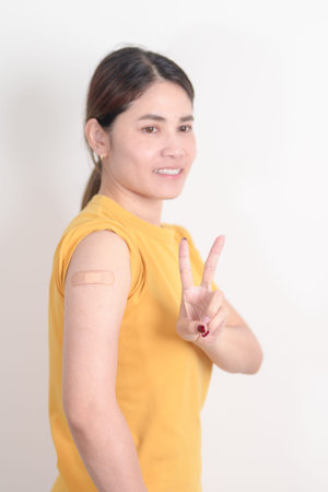 Adult Woman with bandage after received vaccine. Vaccination and Immunization for Influenza, HPV,...