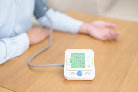 Man checking Blood pressure by Blood pressure monitor with Cuff. Systolic, SYS, Diastolic, DIA,...