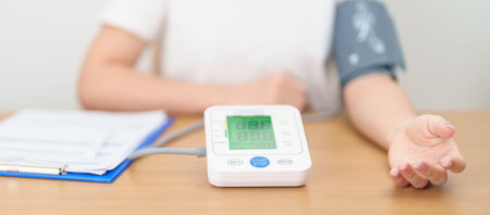 woman checking Blood pressure by Blood pressure monitor with Cuff. Systolic, SYS, Diastolic, DIA,...