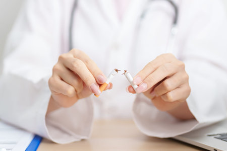 doctor hand making stop sign to refuse and breaking cigarette, quitting smoking for healthy lungs,...