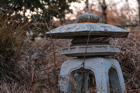 little stone sculpture in wildflower gardenの写真素材