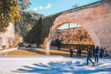 Palma, Mallorca / Spain - March 26 2018: Arch and pond in the front of the Royal Palace of La Almudaina, located in the capital Palma de Mallorca, both the city and the palace are popular with touristsのeditorial素材