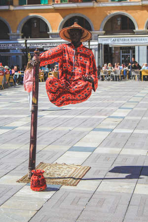 Palma, Mallorca / Spain - March 26 2018: Placa Major in the capital Palma de Mallorca. A street performer is entertaining the people. Floating man.のeditorial素材