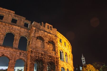 Ancient Roman Amphitheater at night in Pula, Istrian Peninsula in Croatiaの写真素材