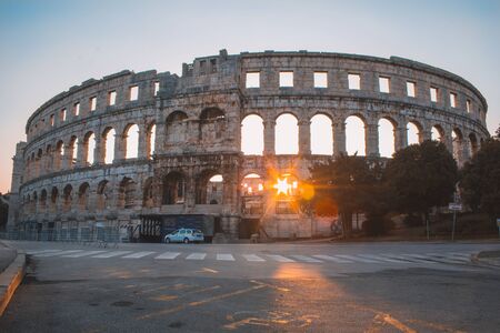 Rovinj, Croatia - July 17 2018: Ancient Roman Amphitheater in Pula, Istrian Peninsula in Croatia. Empty street during early morning.の写真素材