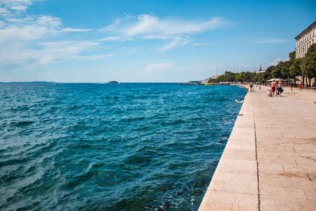 Zadar, Croatia - July 26 2018: Waterfront in the old town of Zadar. People enjoing a summer day by...