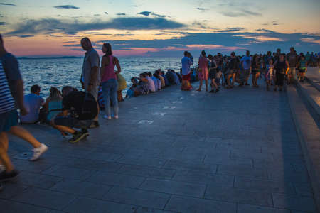 Zadar, Croatia - July 26 2018: Waterfront of Zadar at night. People exploring the Sea Organ which is an experimental musical instrumentのeditorial素材
