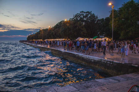 Zadar, Croatia - July 26 2018: Waterfront of Zadar at night. Tourists strolling around the night marketのeditorial素材