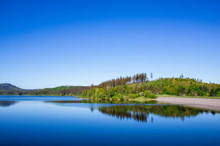 Tranquil view of Granestausee, a reservoir in Harz Mountains National Park, Germanyの写真素材