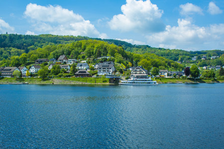 Village Rurberg at Eifel National Park, Germany. Scenic view of lake Rursee and houses in the backgroundの写真素材