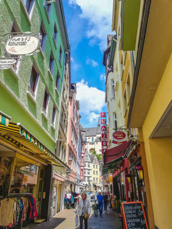 COCHEM, GERMANY - MAY 23 2019: Idyllic old town alley with different shops and people. Cochem is a picturesque town located at Moselle river in Rhineland-Palatinate, Germany.のeditorial素材