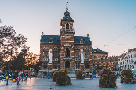 Brussels, BELGIUM - October 8, 2021: Twon Hall of Anderlecht at sunset. Families and people enjoying the sunset at town hall squareのeditorial素材