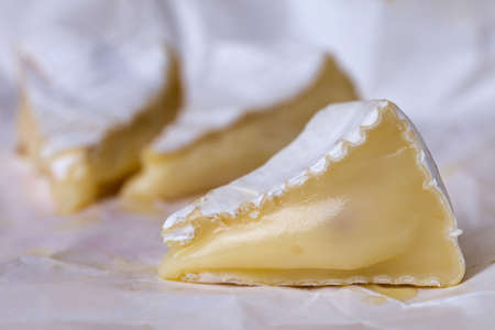 sliced camembert cheese on a white plateの写真素材